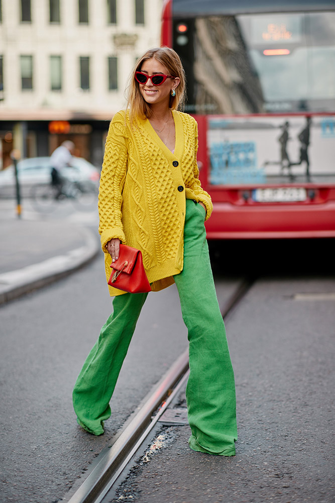 01 stockholm spring 2019 street style yellow chunky knit cardigan green wide leg trousers red bag sunglasses