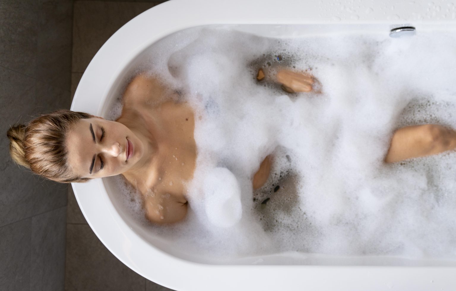 woman enjoying relaxing bubble bath